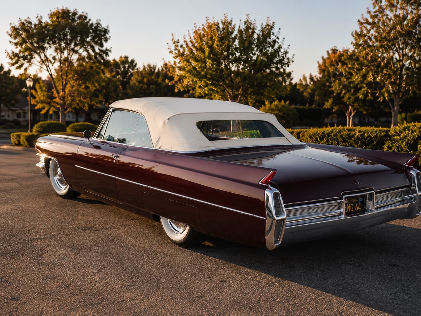 1965 Cadillac Convertible — maroon, white top, side profile